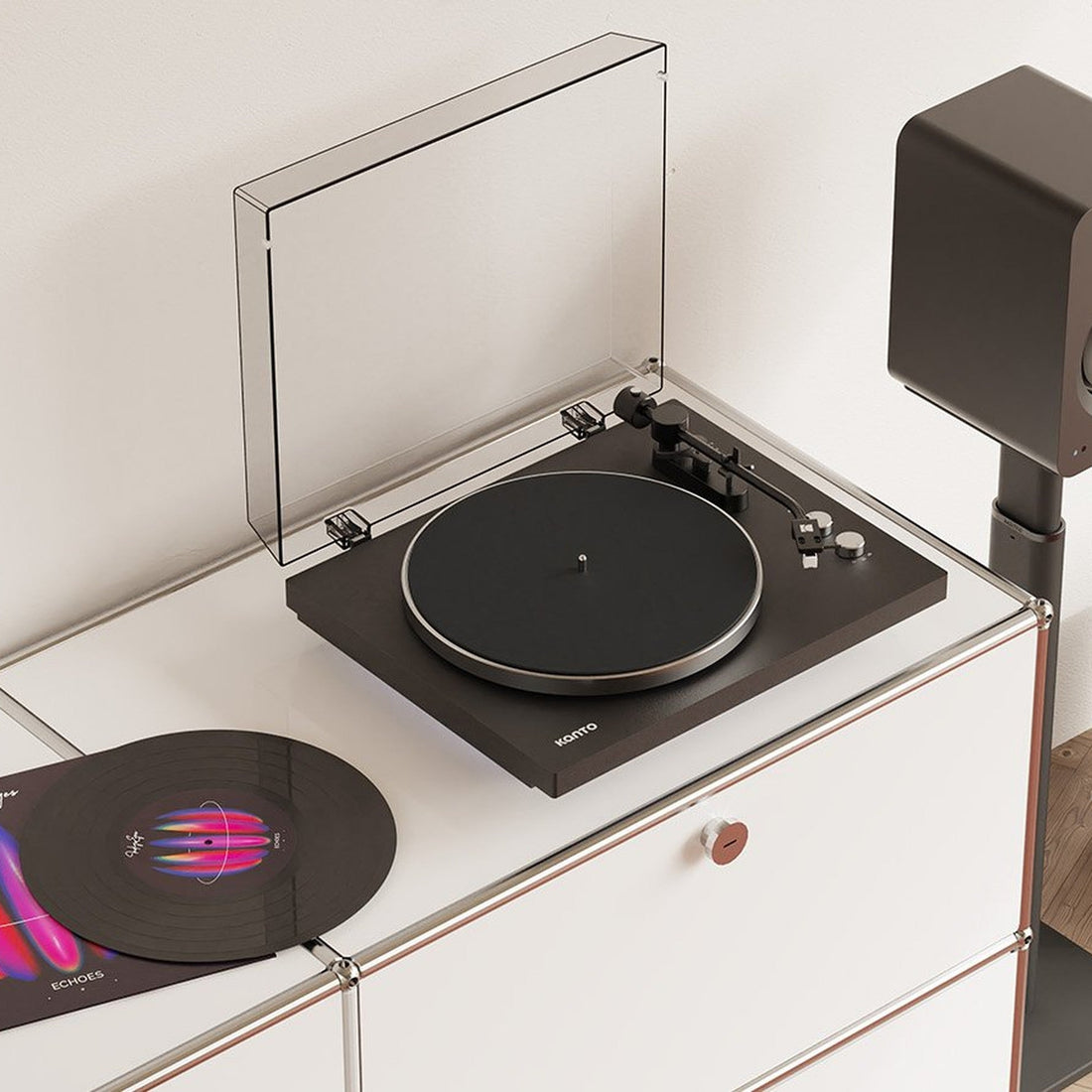 Kanto Audio OBI3 Gen 2 turntable in black, in a living-room hi-fi setup with speaker and vinyl