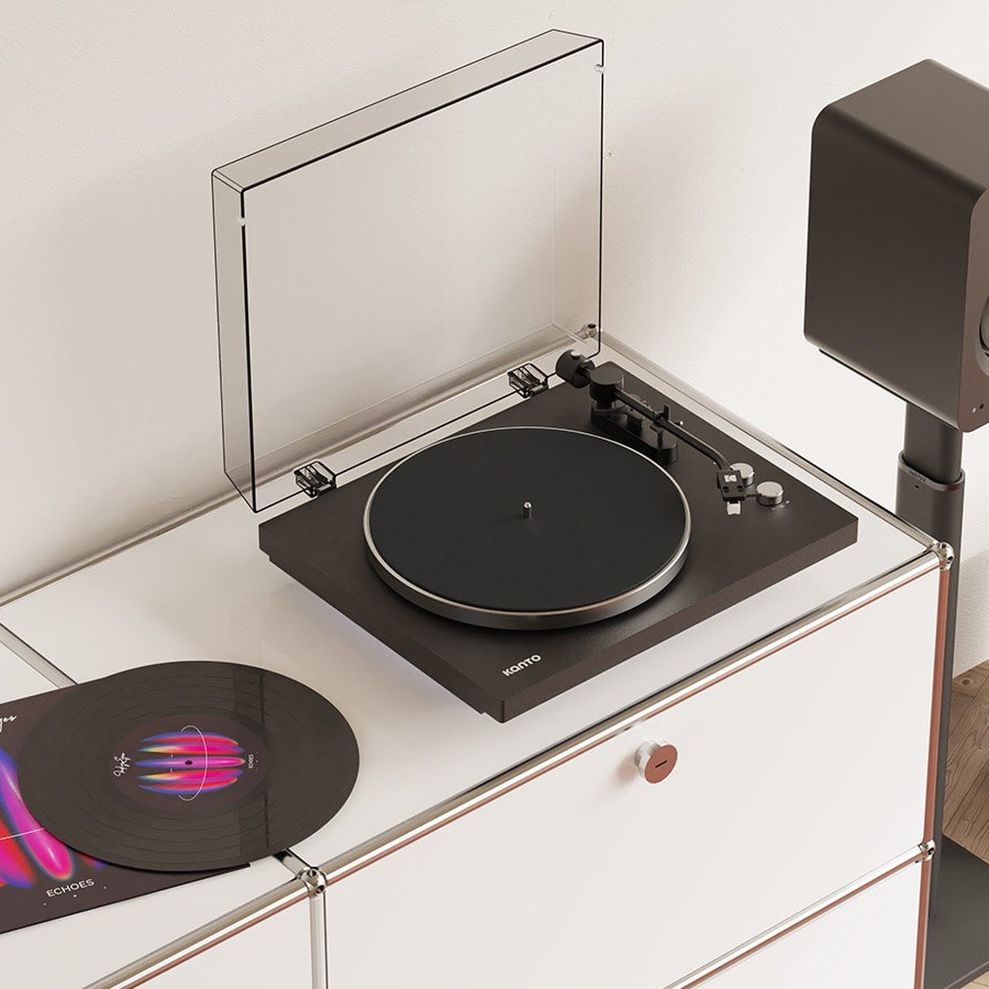 Kanto Audio OBI3 Gen 2 turntable in black, in a living-room hi-fi setup with speaker and vinyl