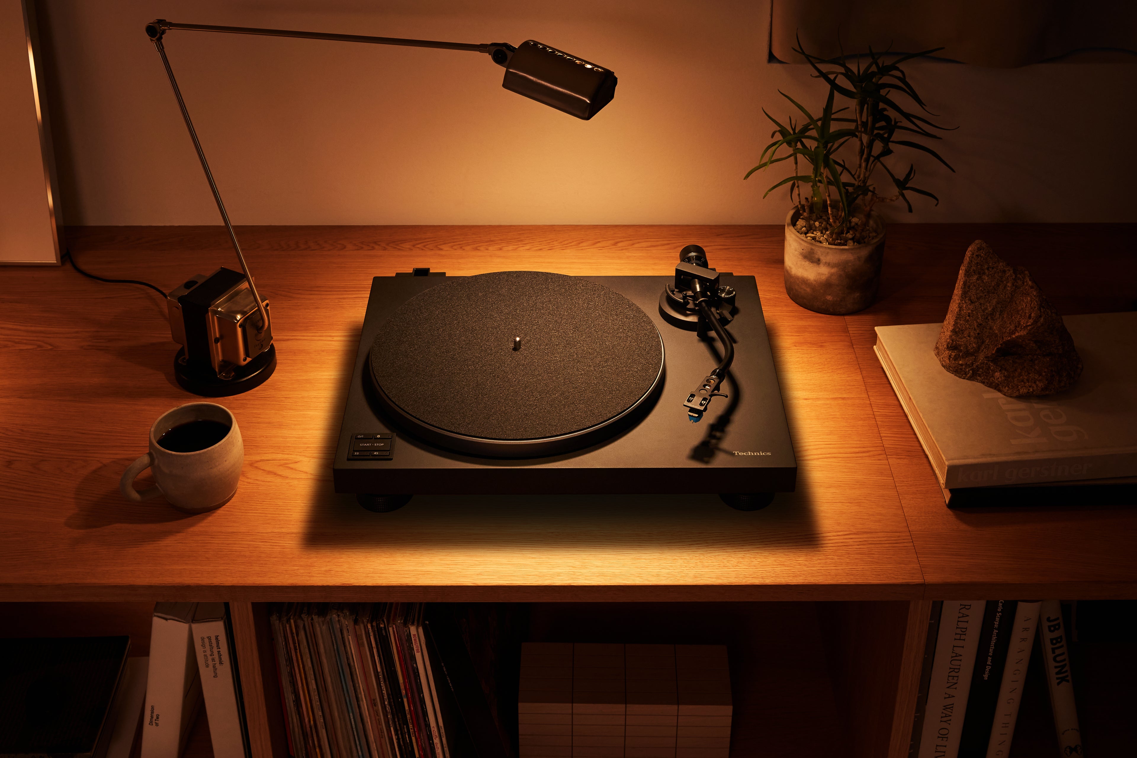 Technics SL-40CBT turntable with a sleek black design, tonearm, and control knobs, ideal for vinyl record listening.