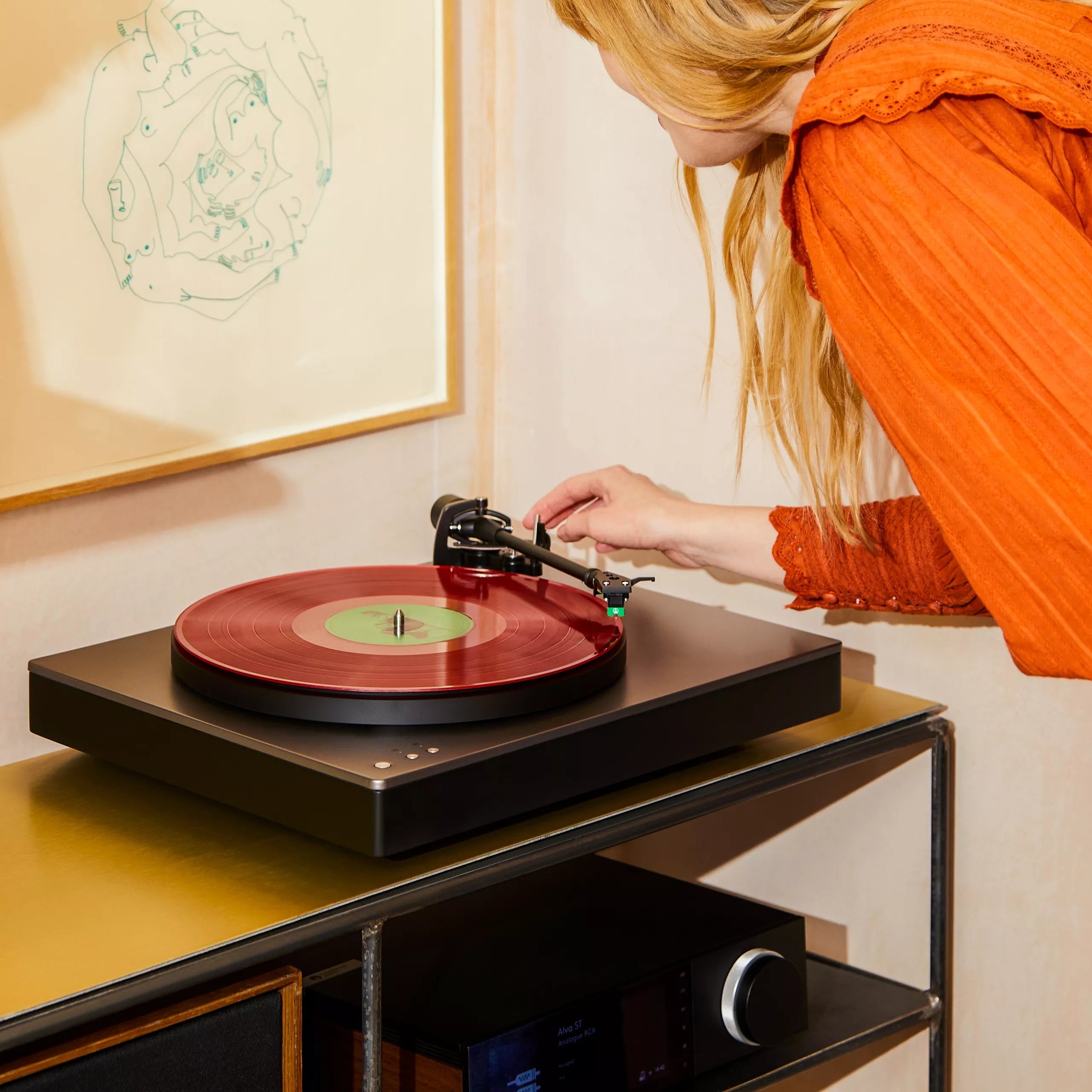 Cambridge Audio Alva ST turntable with sleek modern design, featuring a tonearm and platter for high-quality vinyl playback.