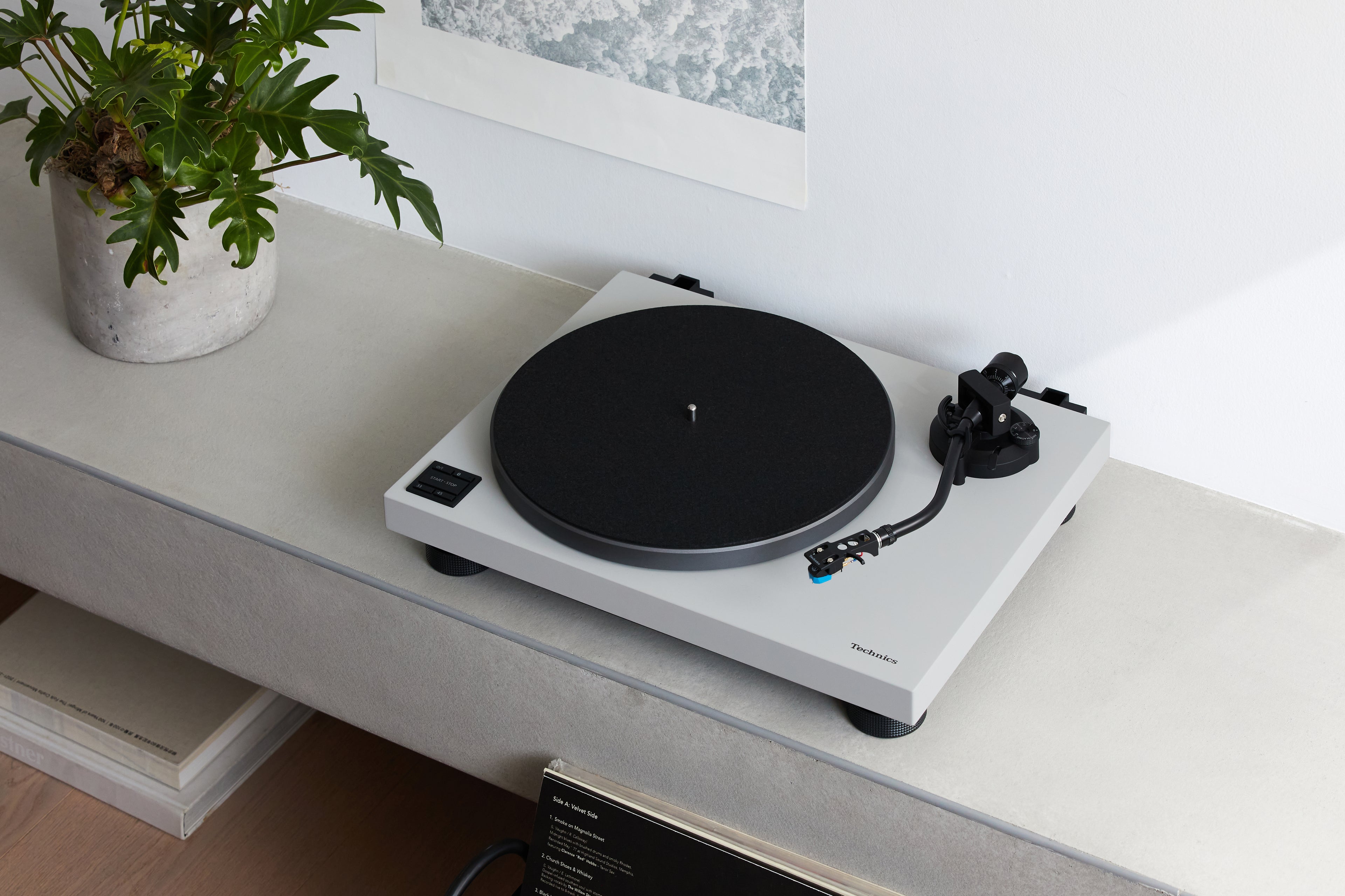 Technics SL-40CBT turntable with a sleek black finish, featuring tonearm and control knobs visible on the top.