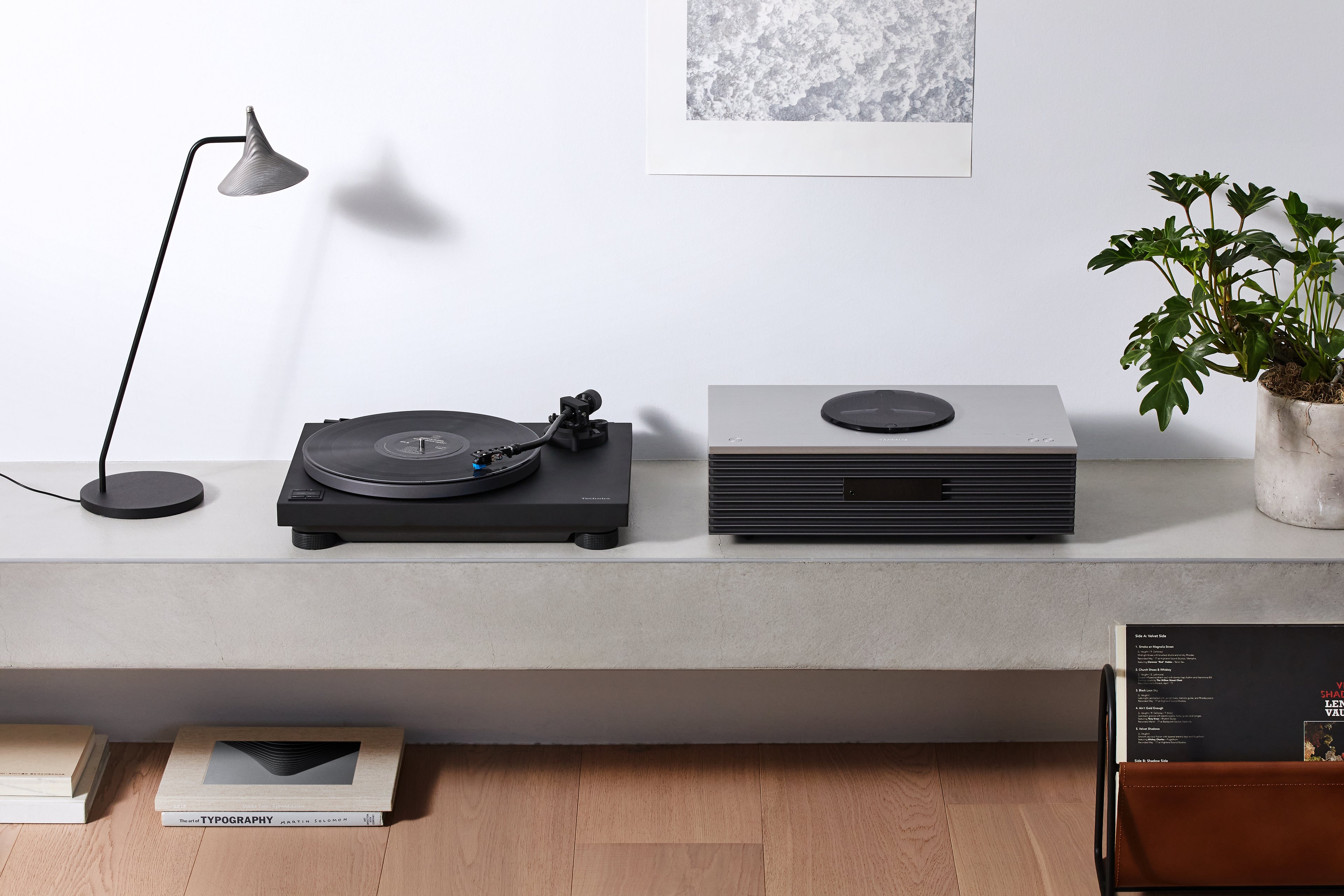 Technics SL-40CBT turntable with black finish, featuring tonearm, platter, and control buttons for high-quality vinyl playback.