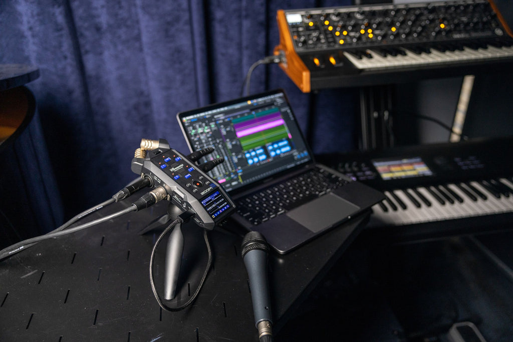 Zoom H6 Essential digital recorder with multiple inputs and professional audio recording capabilities in a lifestyle setting.
