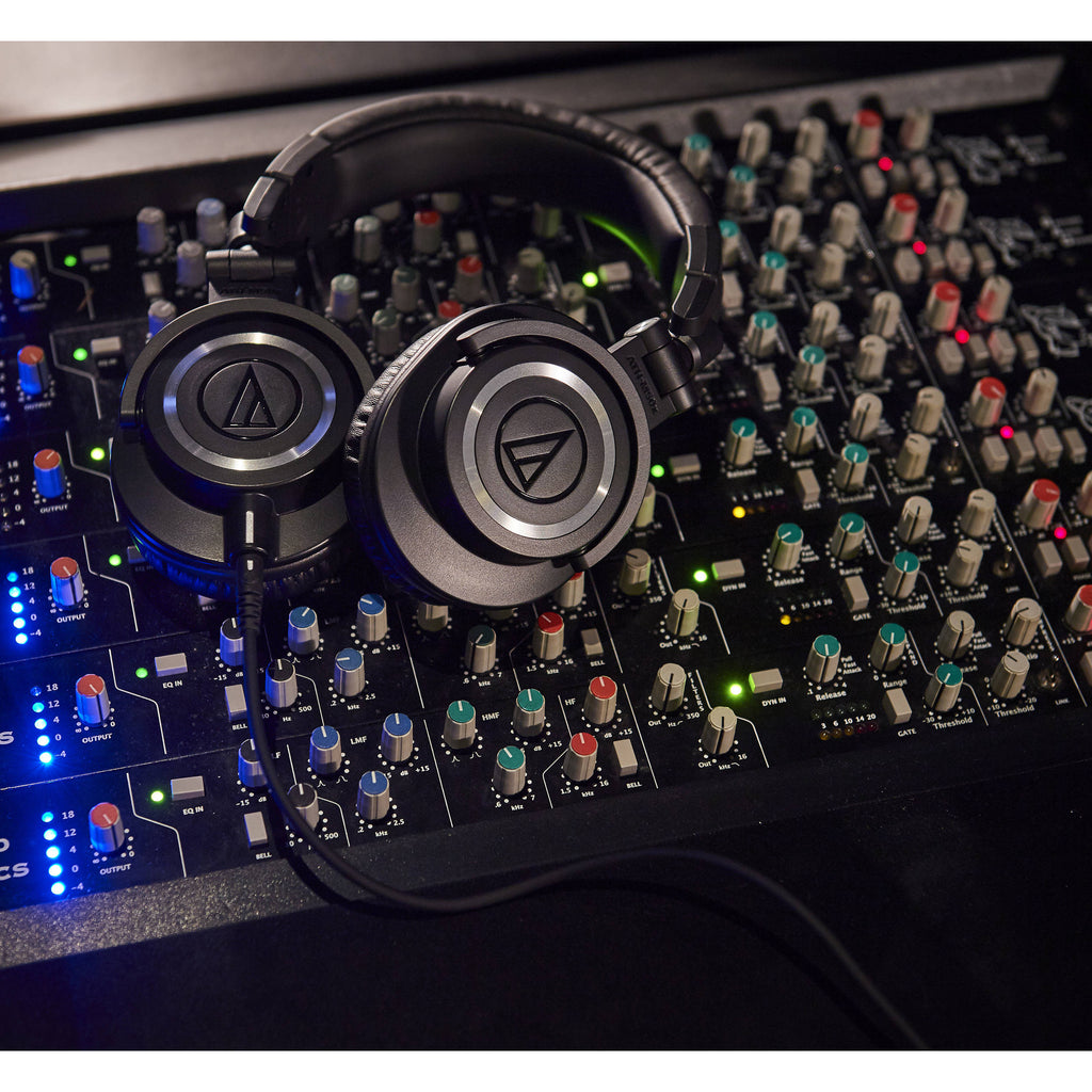 Audio Technica ATH-M50x studio headphones with large ear cups and adjustable headband, shown in a close-up view.
