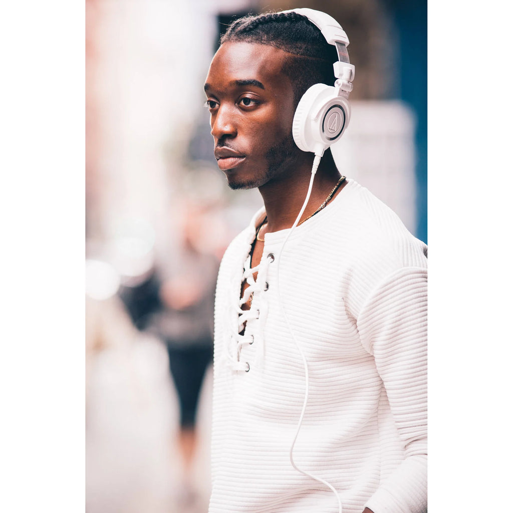 Audio Technica ATH-M50x studio headphones with over-ear design, black color, and padded ear cups for professional listening.