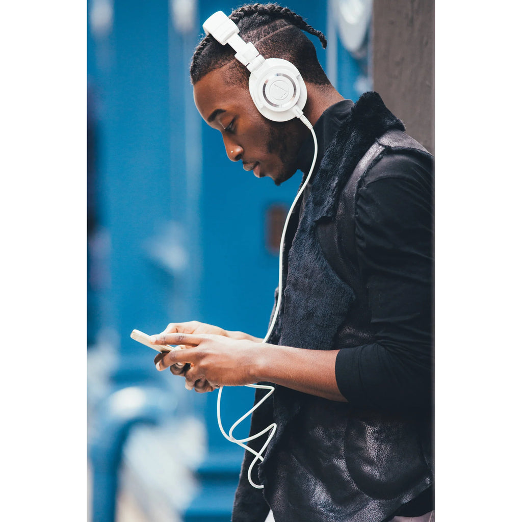 Audio Technica ATH-M50x studio headphones with large over-ear cups and adjustable headband, black color, wired design.