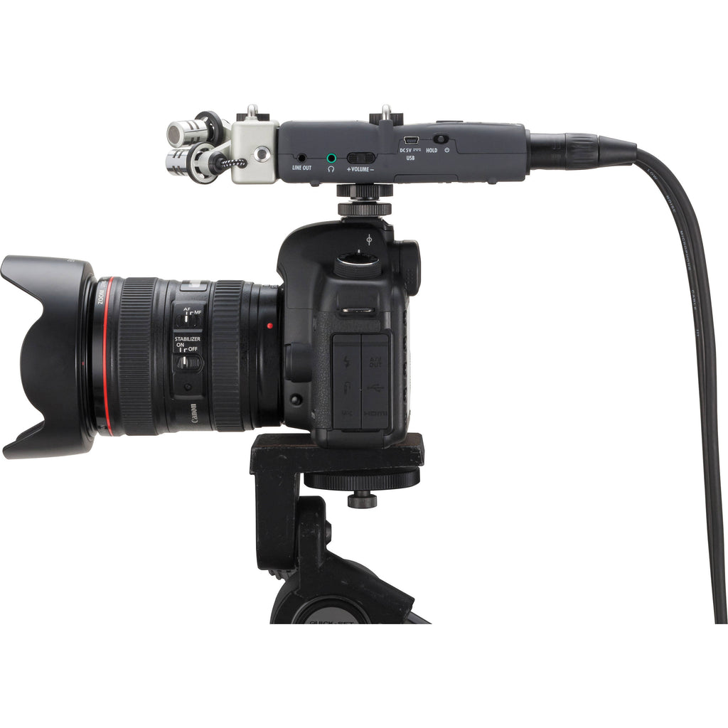 Zoom H5 digital recorder with microphone inputs and compact design, ideal for high-quality audio recording.