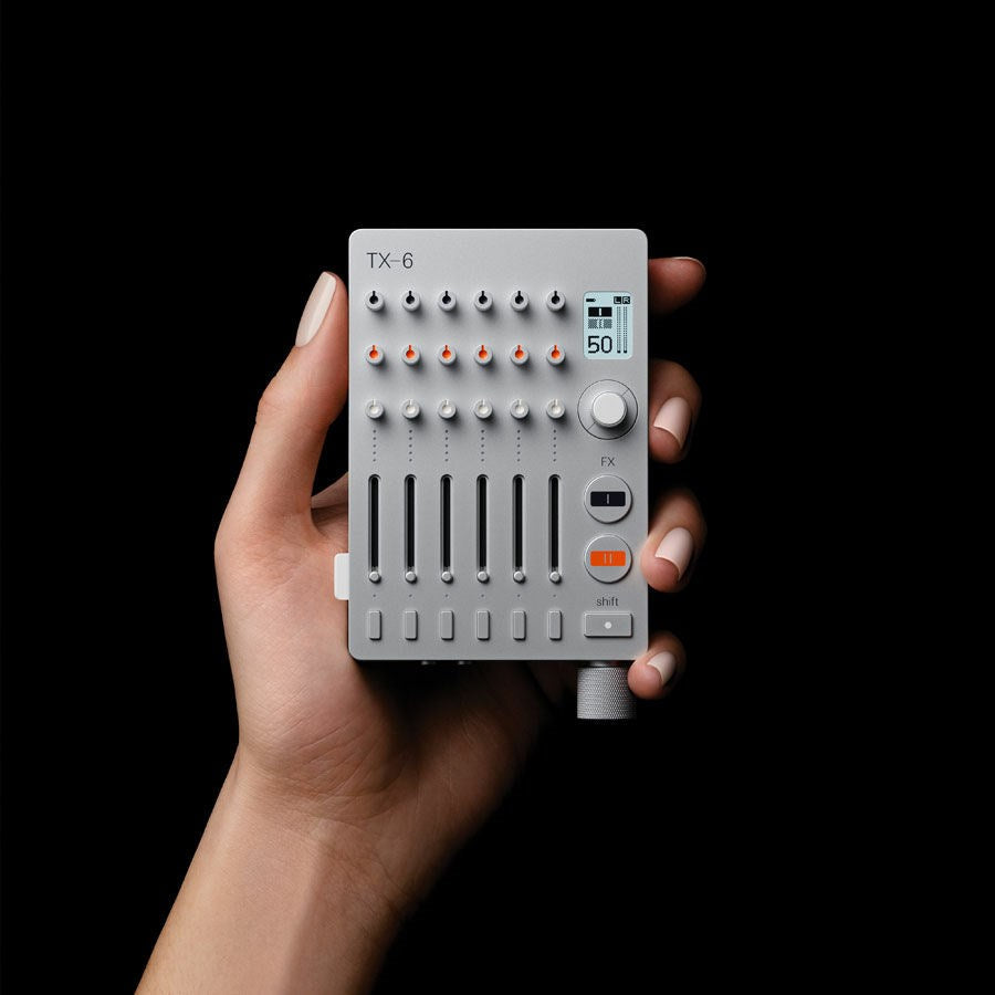 Teenage Engineering TX–6 portable mixer with multiple input channels, compact design, and colorful controls.