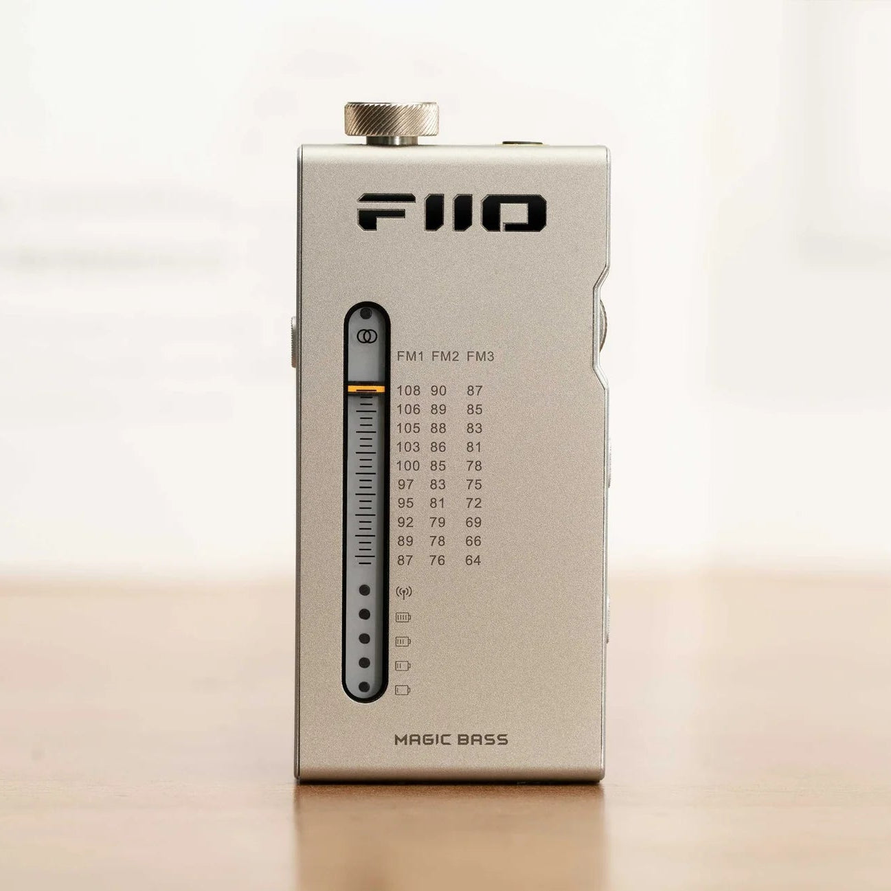 FiiO RR11 radio with digital display, tuning dial, and control buttons on a sleek black finish.
