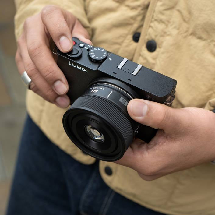 Panasonic Lumix S 40mm F/2.0 lens for video cameras, shown with the camera setup and focus on the lens detail.