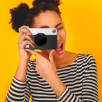 Kodak Printomatic instant compact camera with colorful design and lens, ready for quick photo printing and sharing.