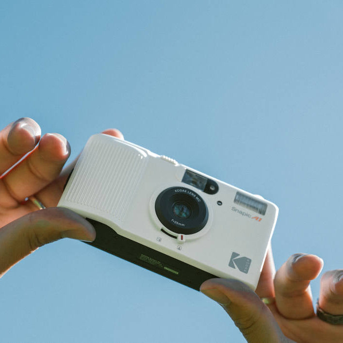 Kodak Snapic A1 instant compact camera with black body and lens, designed for quick, easy photo printing.