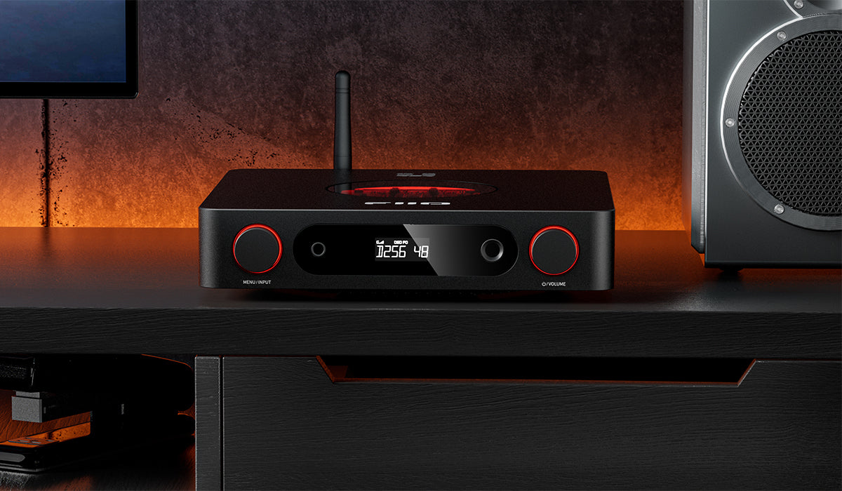 FiiO K13 R2R headphone amplifier and DAC device with digital and analog input ports, compact black design with control buttons