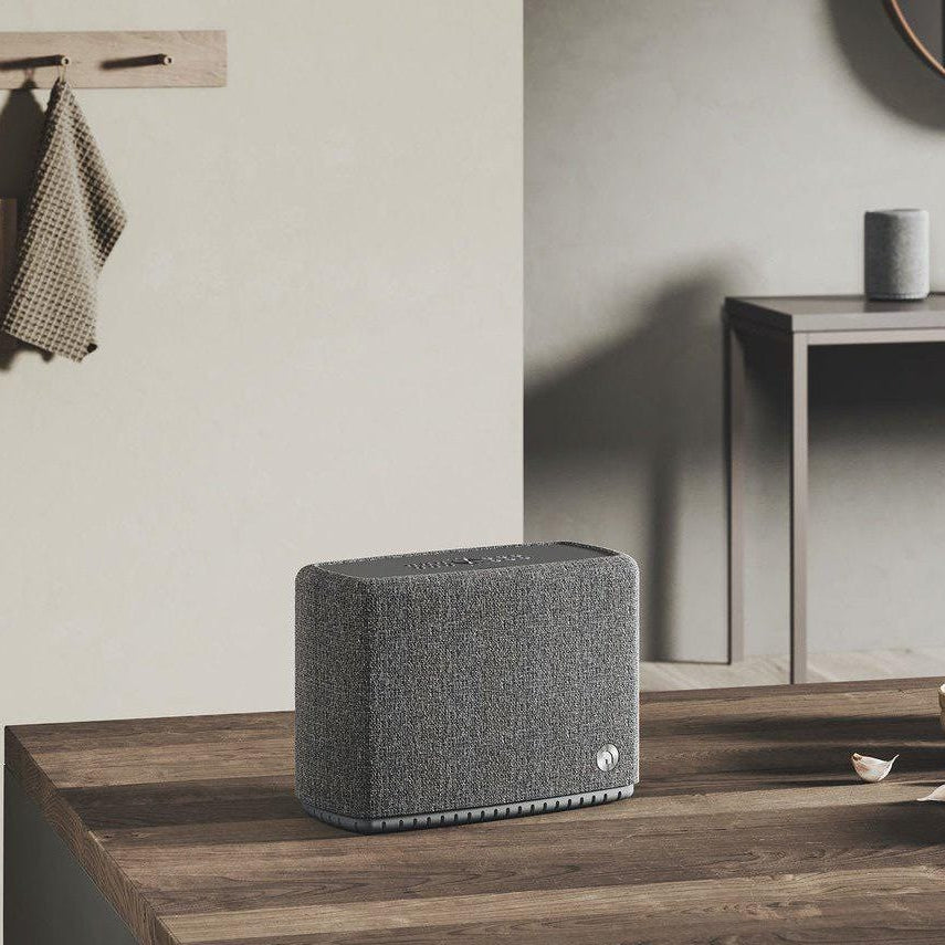 Audio Pro A15 portable speakers in sleek black design with control buttons and fabric mesh grille visible.