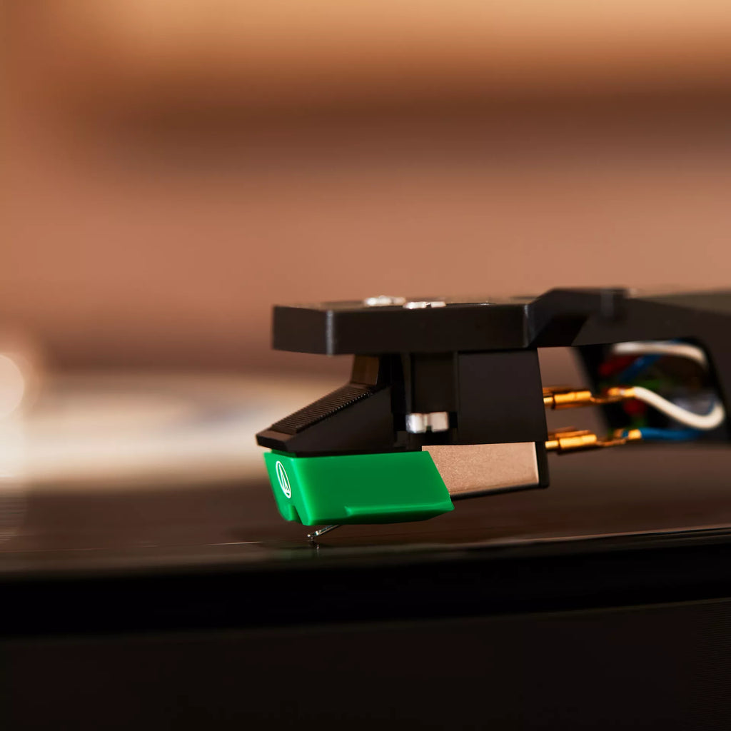 Close-up of the needle on the Cambridge Audio Alva ST turntable, showcasing high-quality audio equipment in a lifestyle setting.