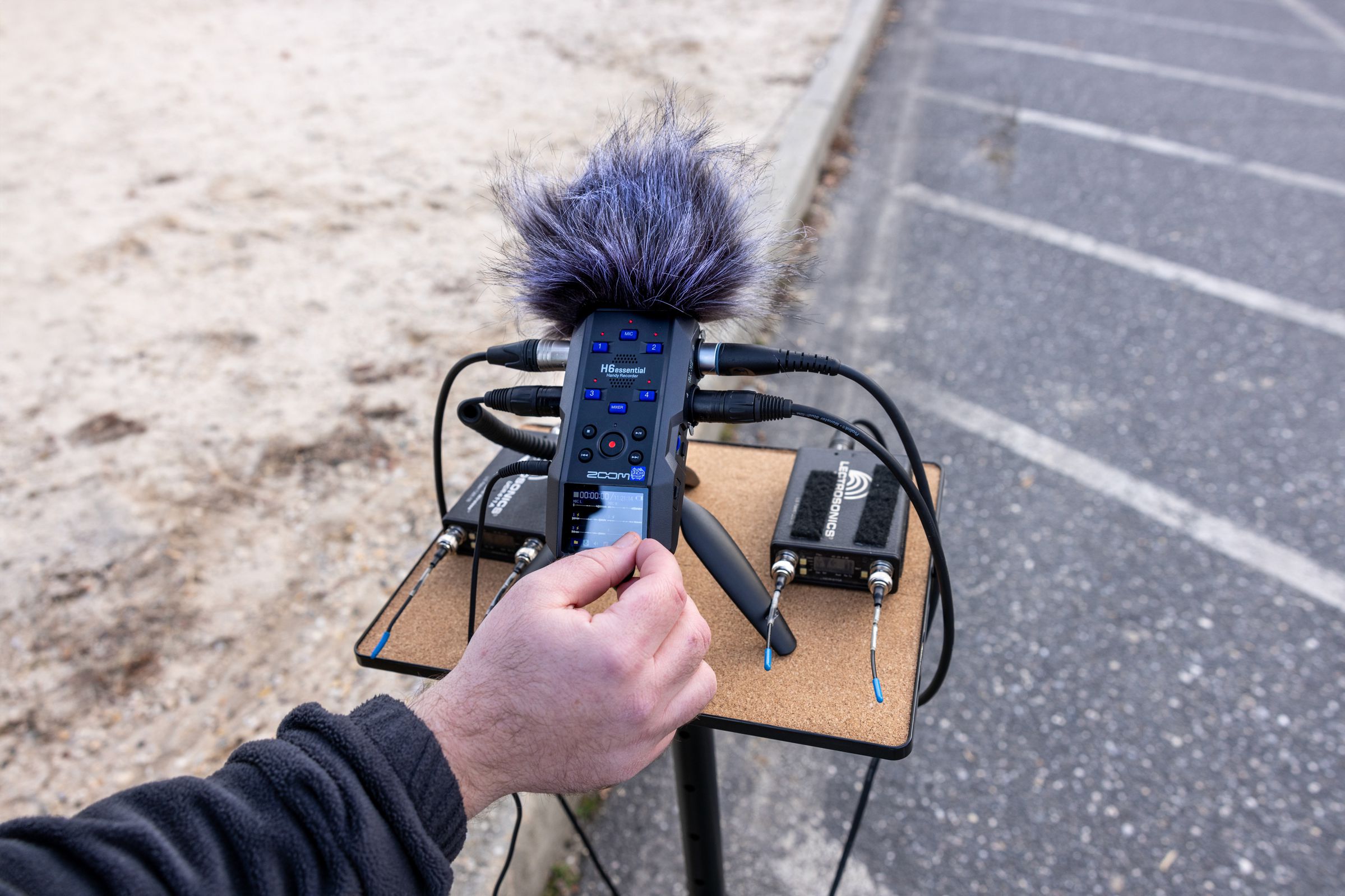 Zoom H6 Essential digital recorder with multiple input options and portable design, shown in a lifestyle setting.