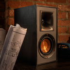 Klipsch R-51PM active bookshelf speakers with black finish and front-facing controls, designed for high-quality audio playback.