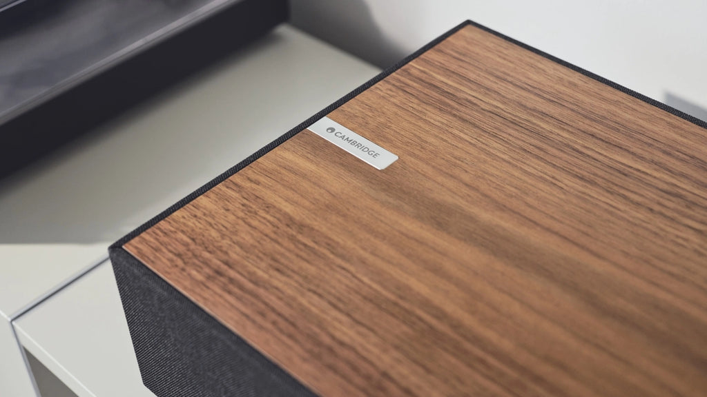 Cambridge Audio Evo One wireless speaker with sleek design, showing front grille and control buttons on a white background.