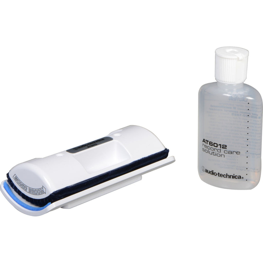 Audio Technica record cleaning kit with brushes and cleaning solution for vinyl records, designed for effective dirt removal.