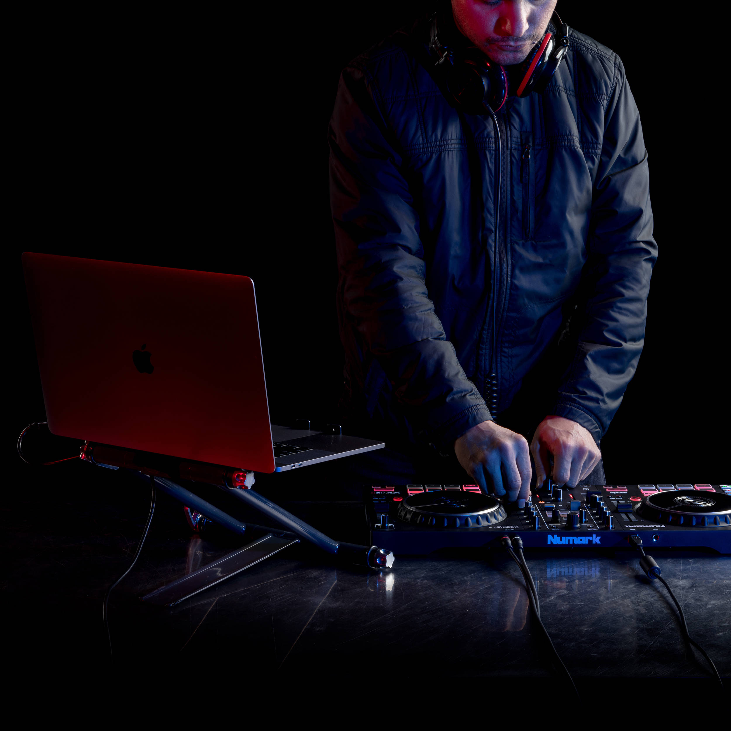 Numark Mixtrack Pro FX DJ controller with jog wheels, sliders, and control buttons for mixing music.