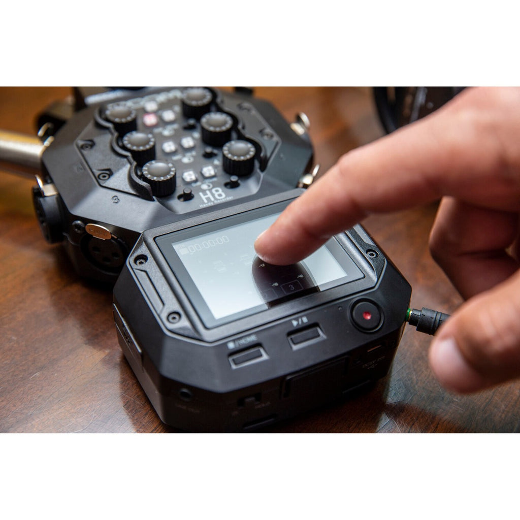 Zoom H8 digital recorder with multiple input ports and colorful display screen, used for professional audio recording.