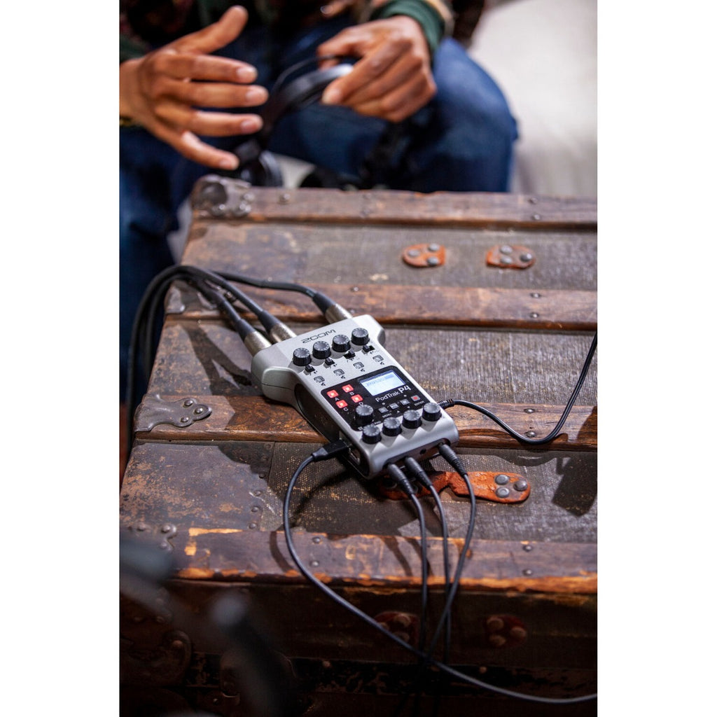 Zoom PodTrak P4 digital recorder with microphones and controls, compact portable recording device for podcasts and audio projects.