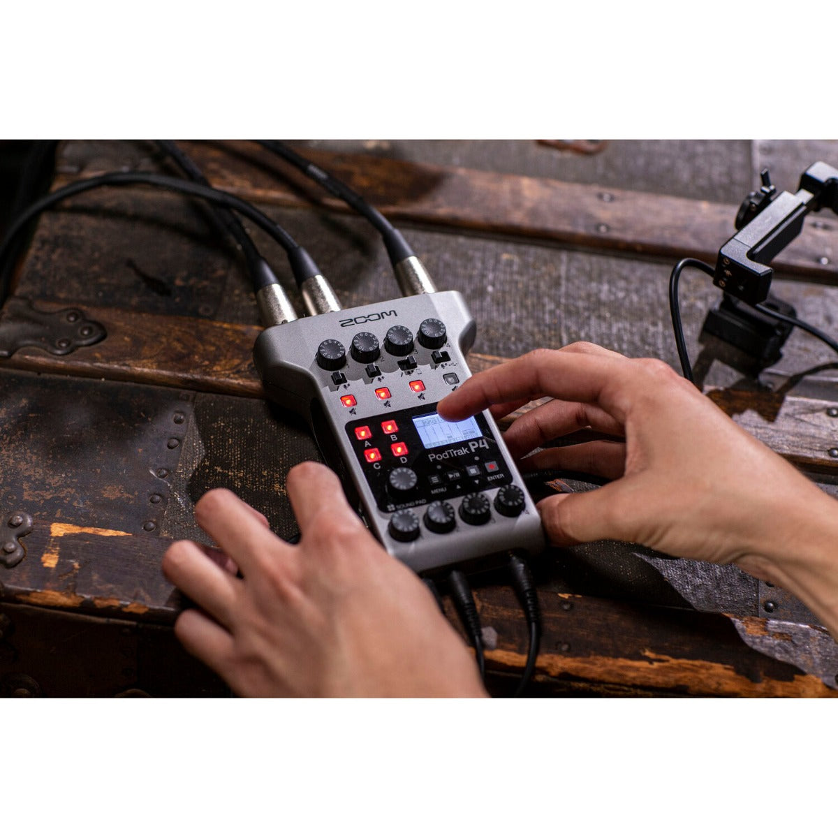 Zoom PodTrak P4 digital recorder with microphone inputs and control knobs, compact portable design for podcast recording