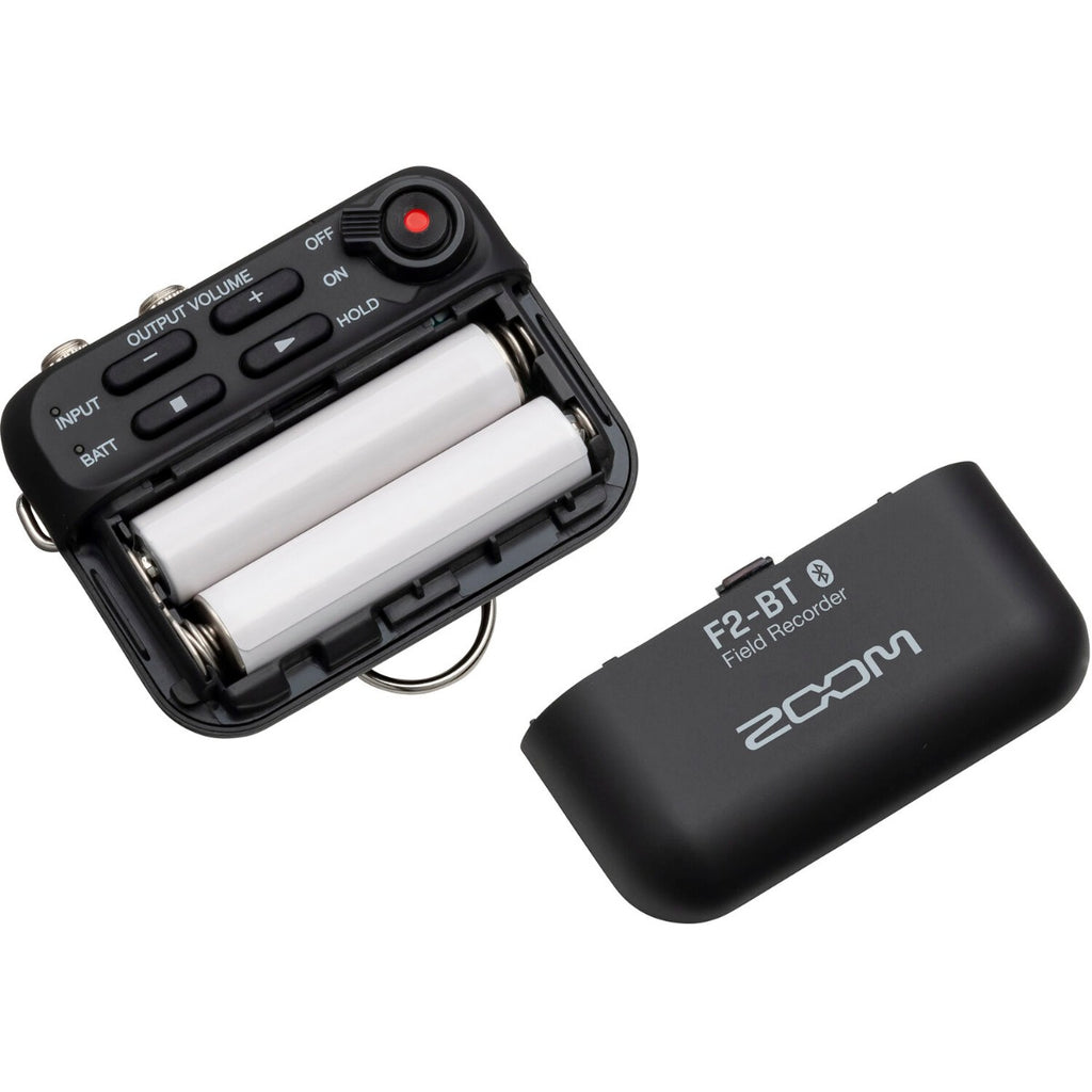 Zoom F2-BT digital recorder with compact design, built-in microphone, and control buttons for high-quality audio recording.