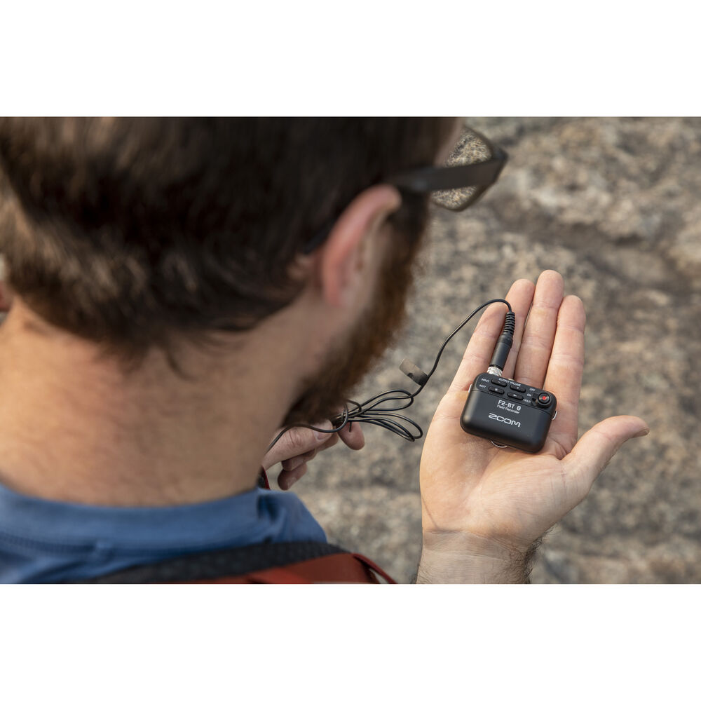 Zoom F2-BT digital recorder with built-in microphone and compact design, perfect for high-quality audio recording.