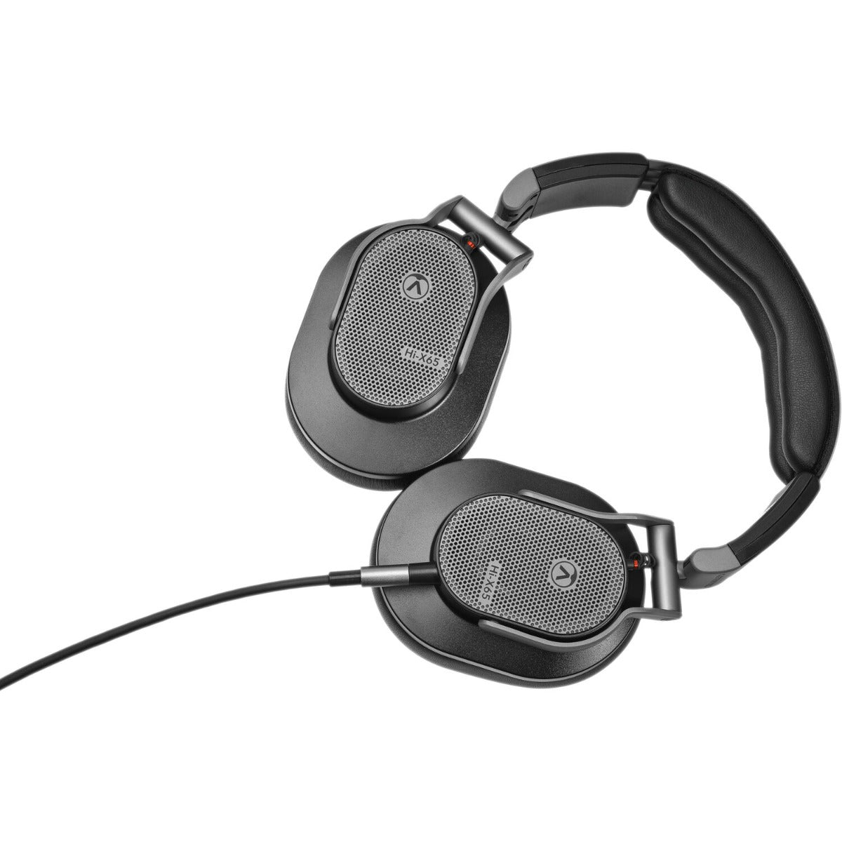 Austrian Audio Hi-X65 studio headphones with over-ear design and adjustable headband, shown resting on a white surface.