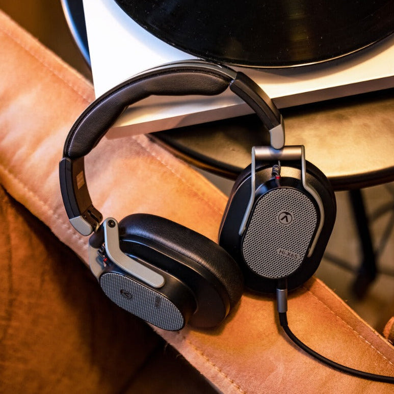 Austrian Audio Hi-X65 studio headphones with black ear cups and headband, showing over-ear design and adjustable headband.