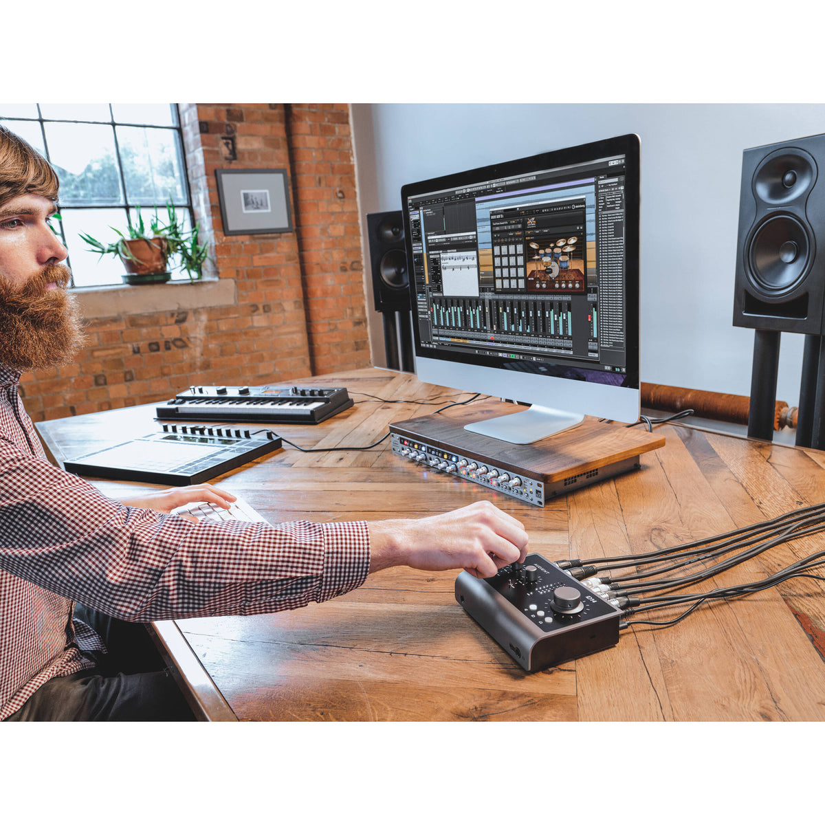 Audient iD14 MK2 audio interface with dual combo inputs, LED meters, and sleek black design for professional music production.