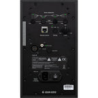 Adam Audio A4V active nearfield monitors on a desk, showing their sleek black design and front grille with branding.