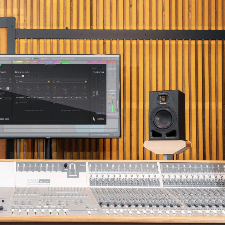 Adam Audio A7V studio monitors featuring a sleek design and high-quality drivers in a modern studio setting.