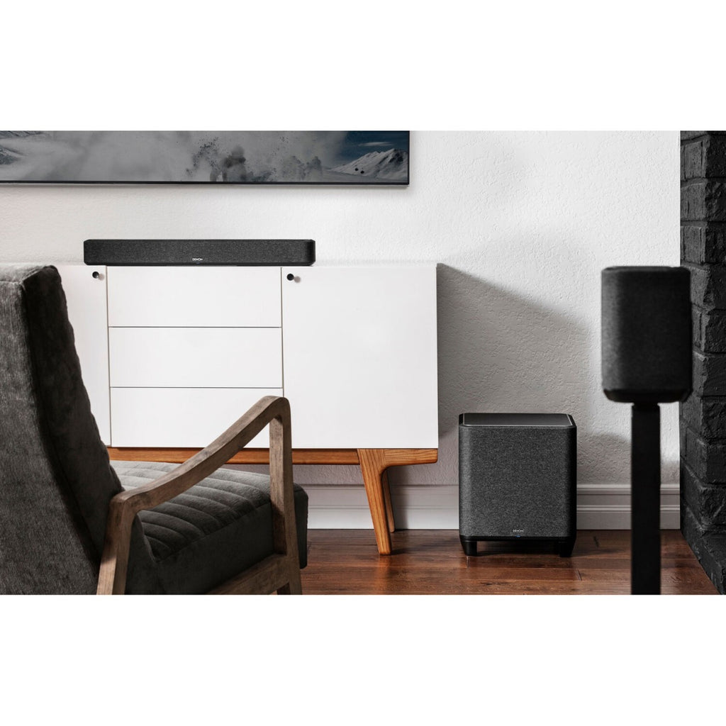 Denon Home Subwoofer showing a sleek black subwoofer with a round speaker grille and modern design.