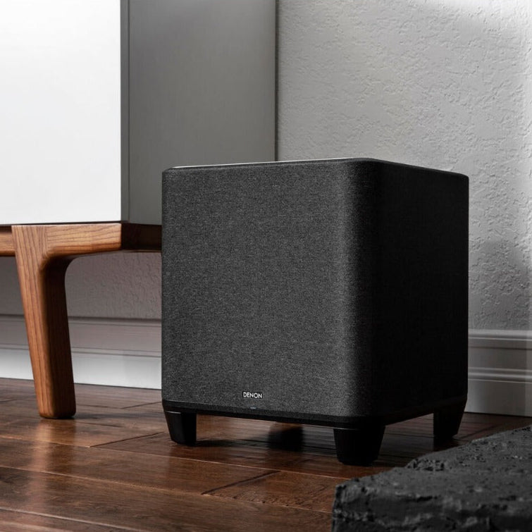 Denon Home subwoofer with sleek black design, showcasing a compact speaker suitable for enhancing home audio systems.