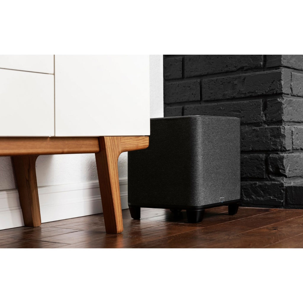 Denon Home Subwoofer with sleek black design, showcasing its compact shape and connection ports on the back.