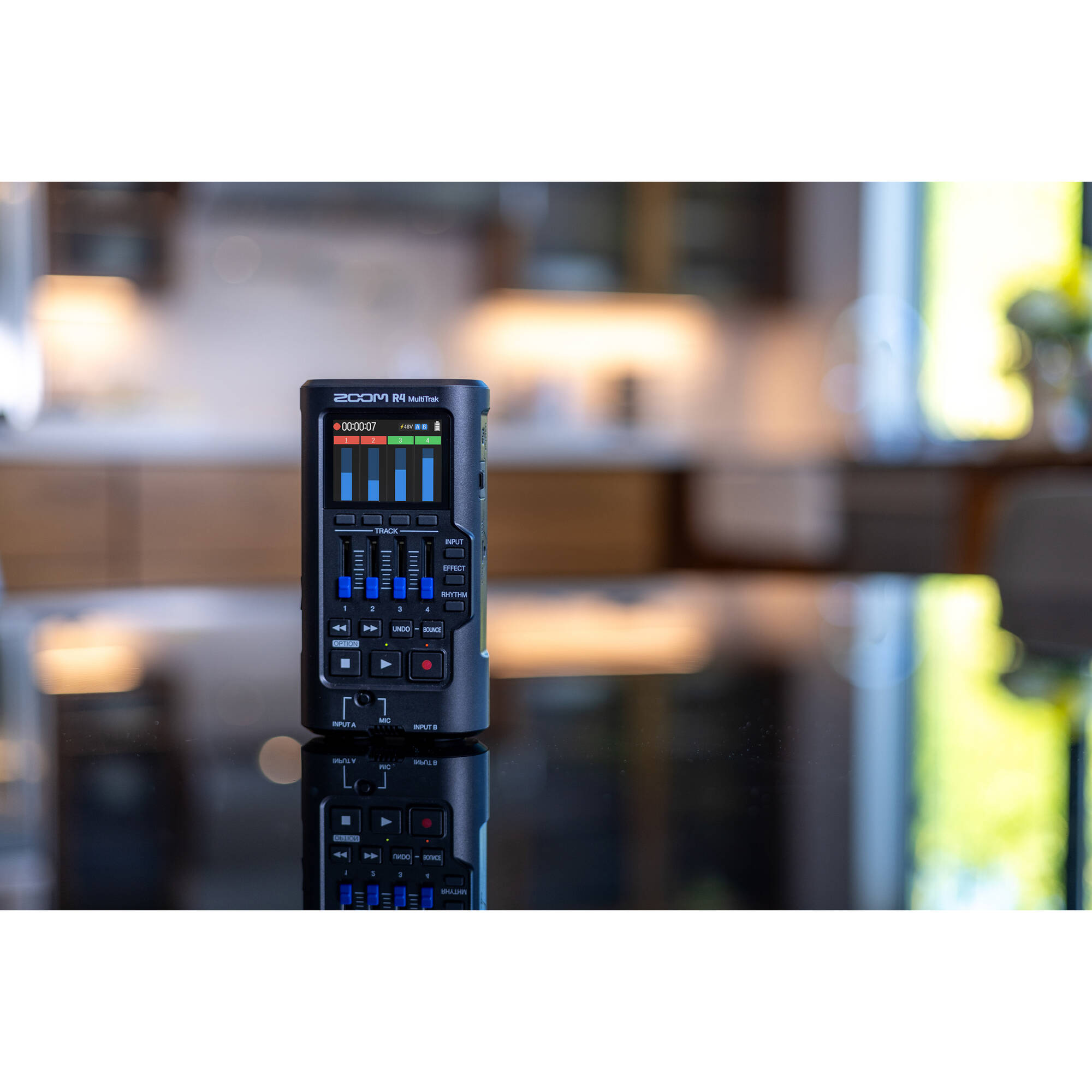 Zoom R4 MultiTrak digital recorder with four channels, LCD screen, and multiple input options for professional audio recording.