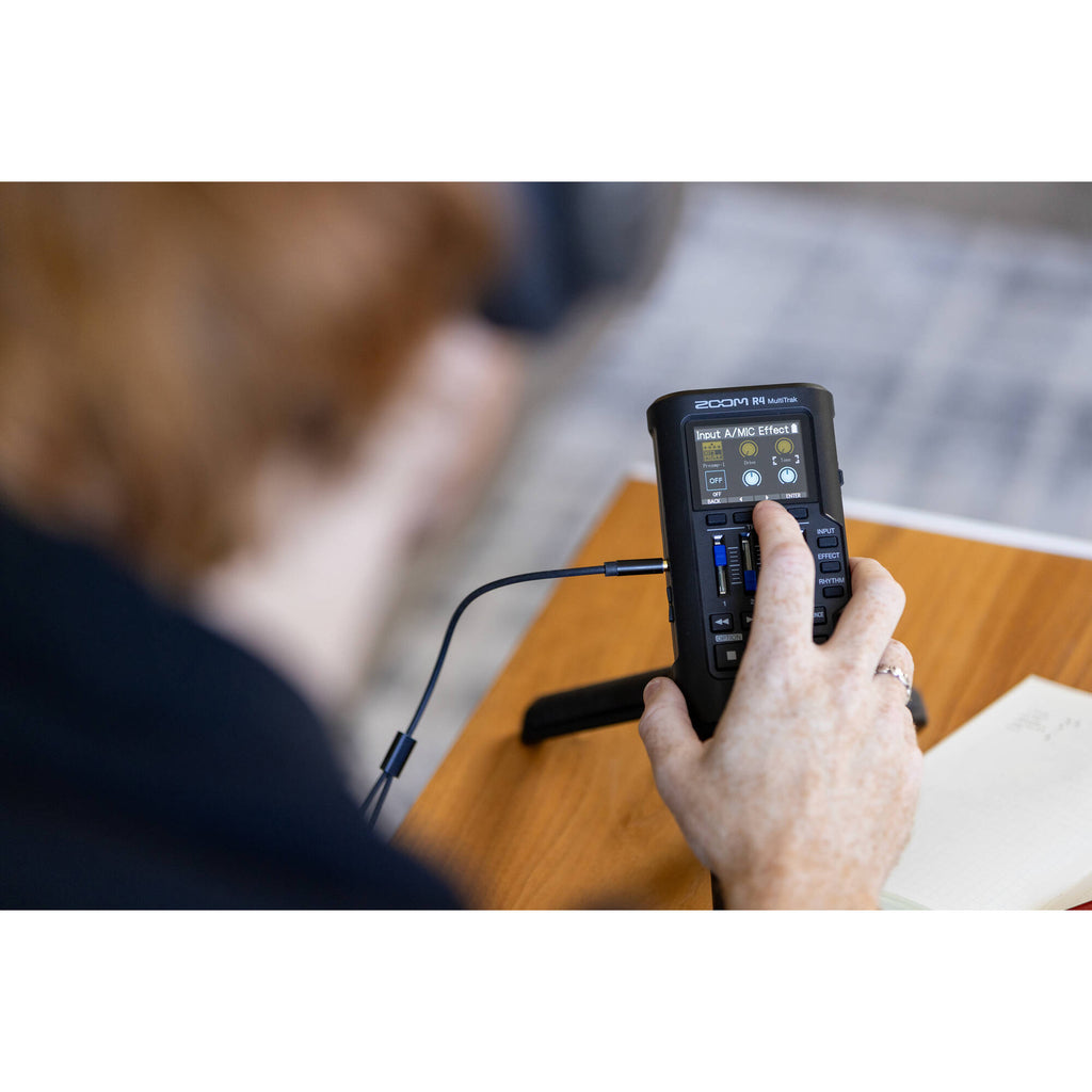 Zoom R4 MultiTrak digital recorder with multiple input jacks, LCD screen, and control buttons for music and audio recording.