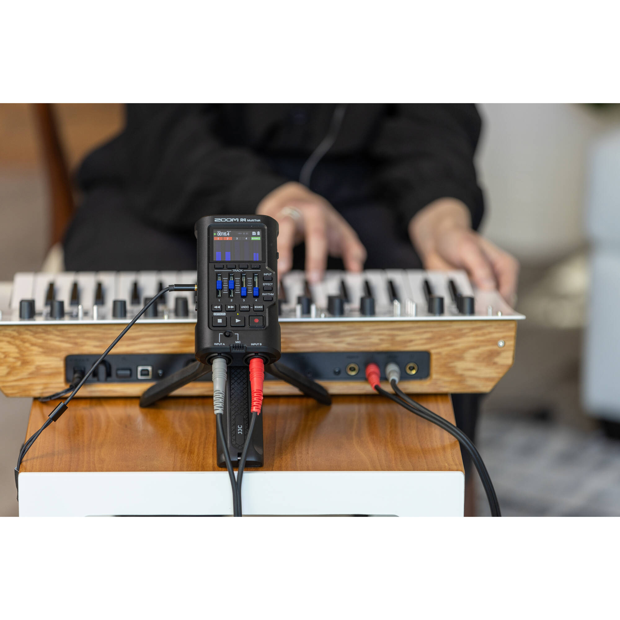 Zoom R4 MultiTrak digital recorder with multiple input jacks, LCD screen, and control buttons for portable audio recording.