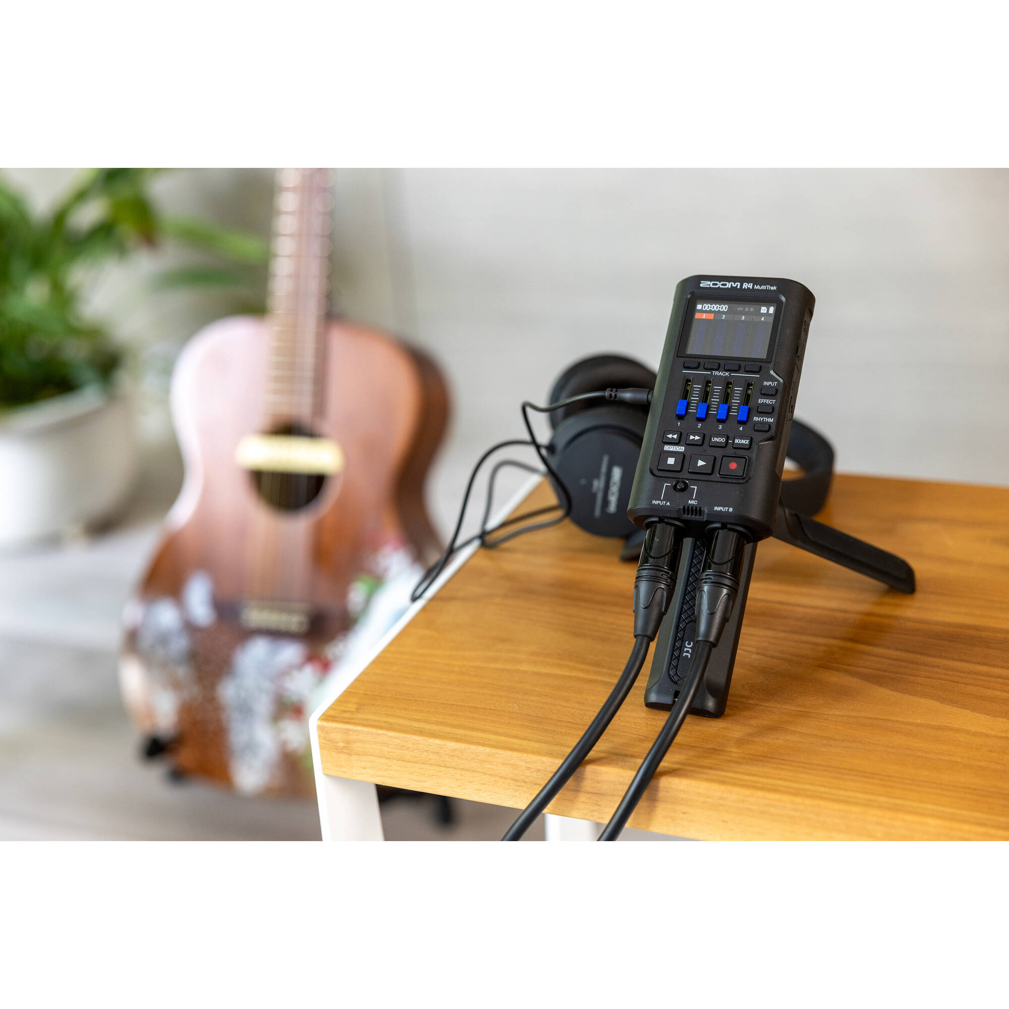 Zoom R4 MultiTrak digital recorder with four input channels, LCD screen, and multiple control knobs for versatile audio recording.