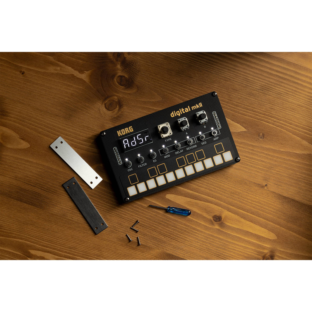 Korg Nu:Tekt NTS-1 MK2 digital synthesizer kit, showing the compact synthesizer with control knobs and a small display screen.
