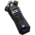 Zoom H1essential digital recorder shown with its compact design, microphone grille, control buttons, and built-in LCD display.
