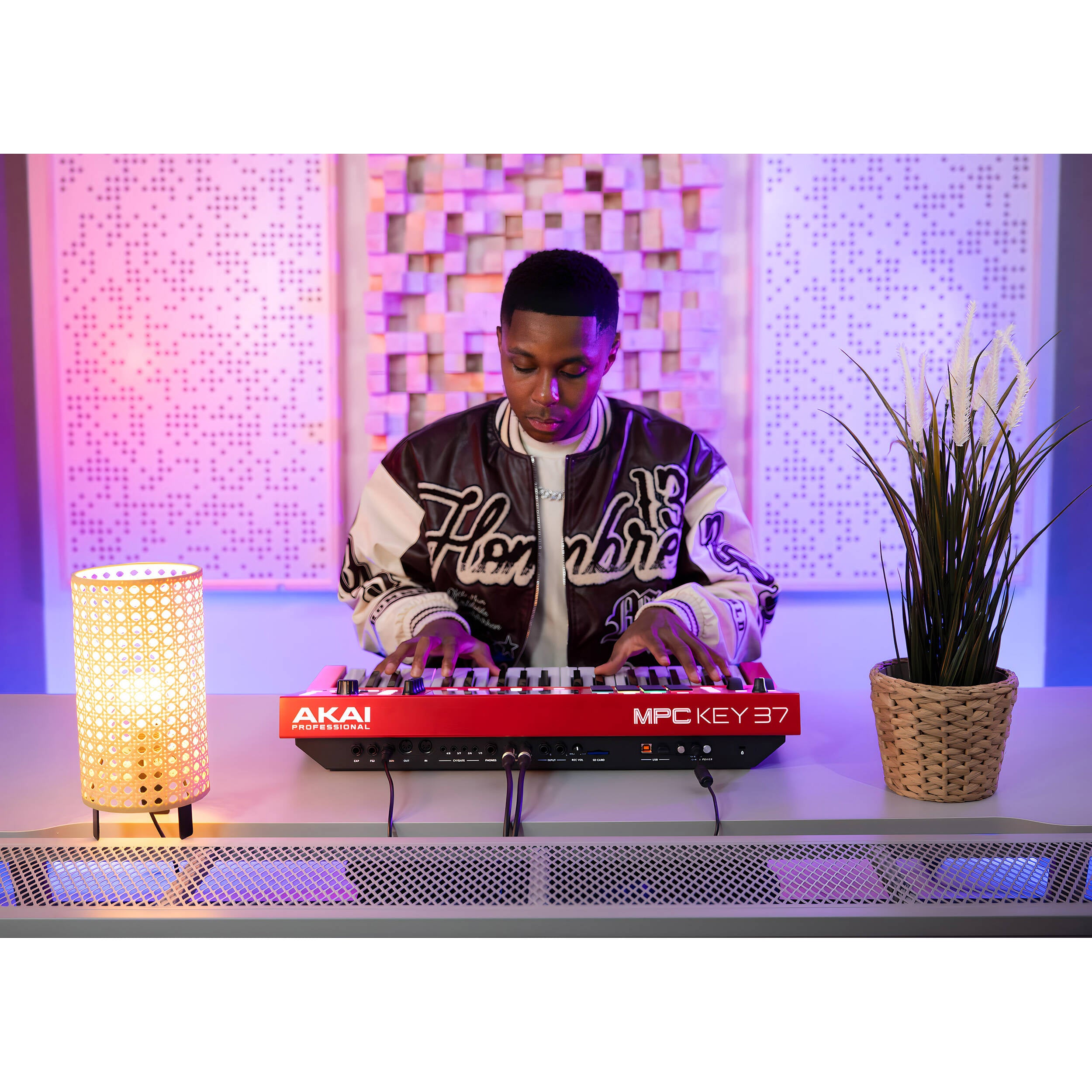 Akai Professional MPC Key 37 red drum machine and sampler with keys and control pads, used for music production.