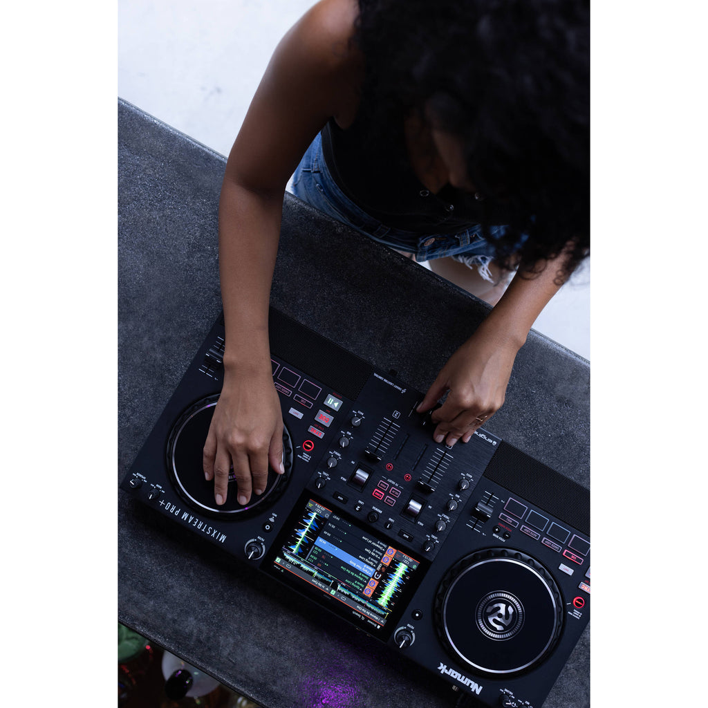 Numark Mixstream Pro+ DJ media player with touchscreen display and control knobs, showcasing professional DJ equipment.