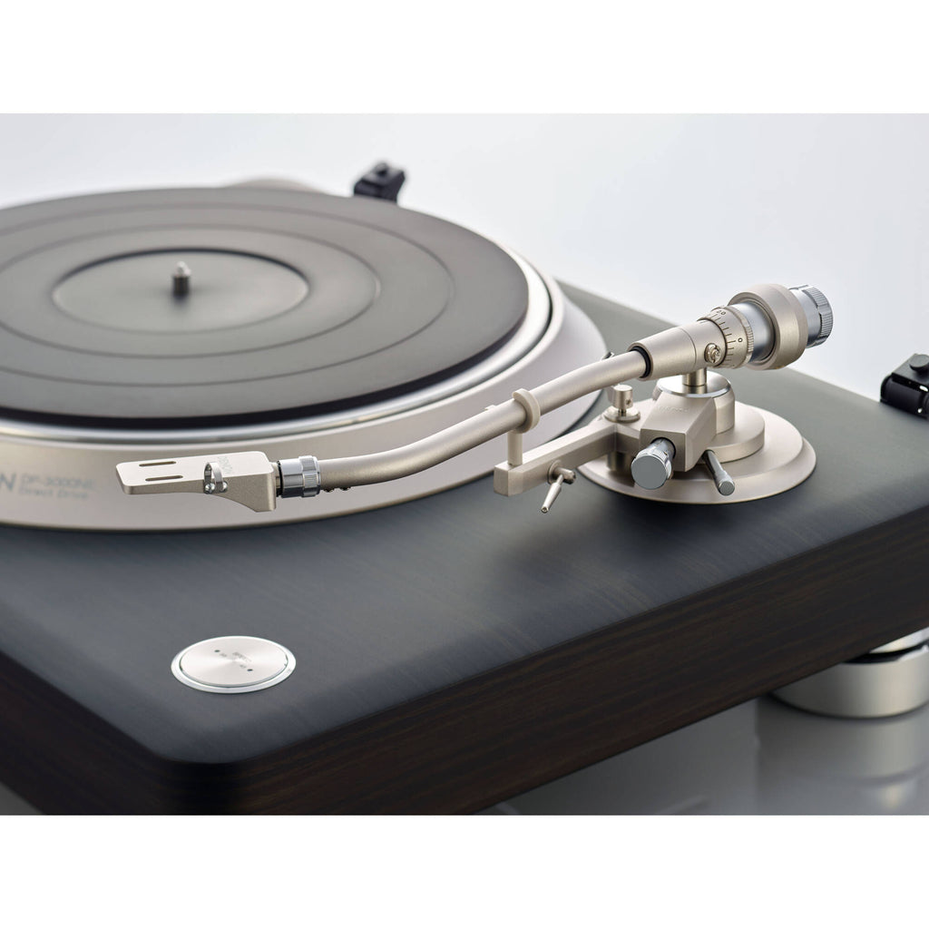 Denon DP-3000NE turntable with wooden finish and tonearm, showcasing its classic design and platter for vinyl records.