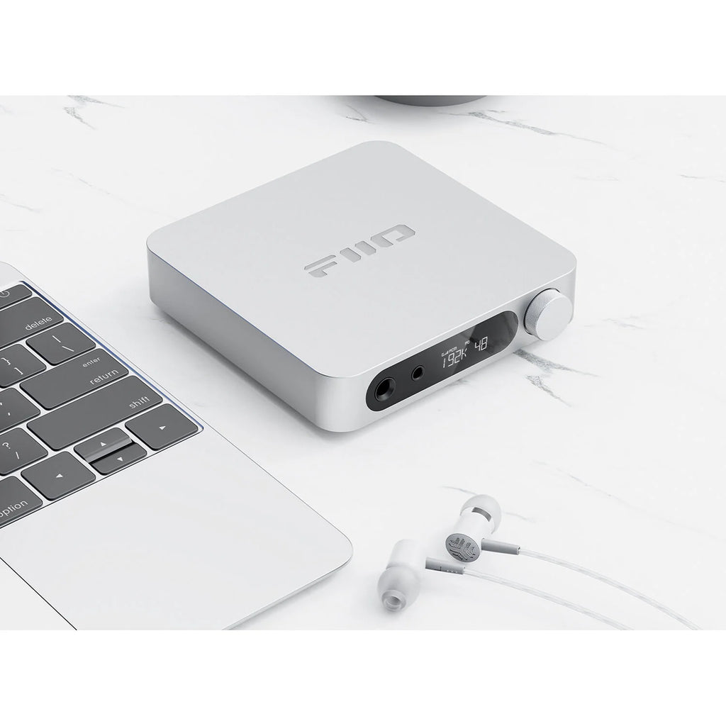 FiiO K11 headphone amplifier and DAC with sleek black design and visible control knobs on the front panel.