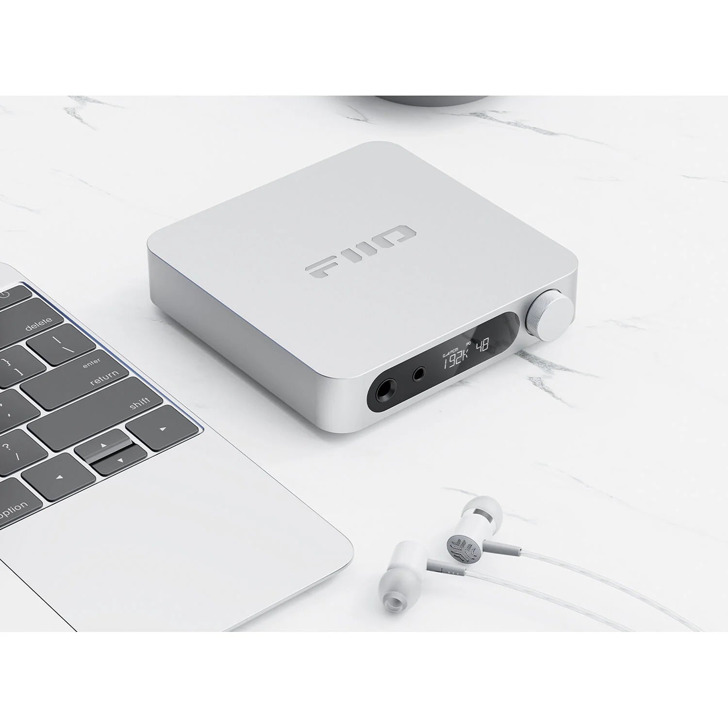 FiiO K11 headphone amplifier and DAC with sleek black design and visible control knobs on the front panel.