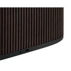 Bang & Olufsen Beosound A5 portable speaker with sleek design, control buttons, and fabric grille in a stylish setting.