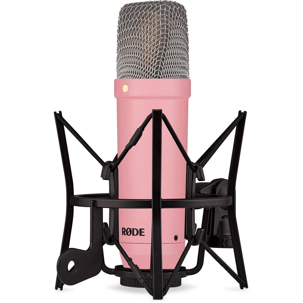 Rode NT1 Signature Series condenser microphone with gold finish and professional recording capsule, positioned on a stand.